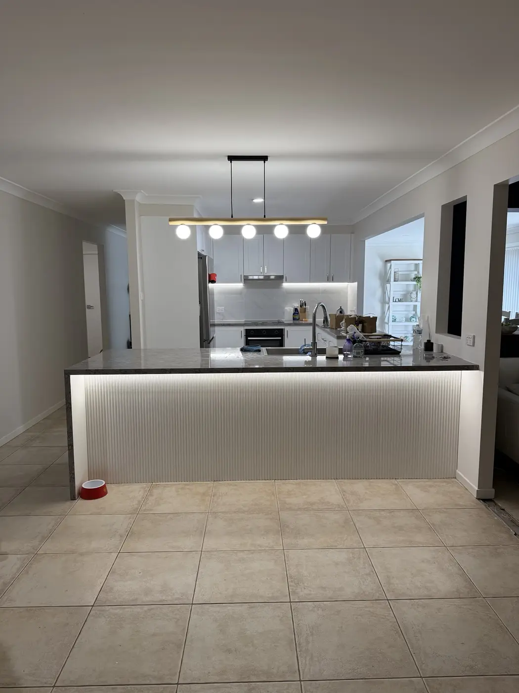 Pendant and LED strip lighting installed in a kitchen